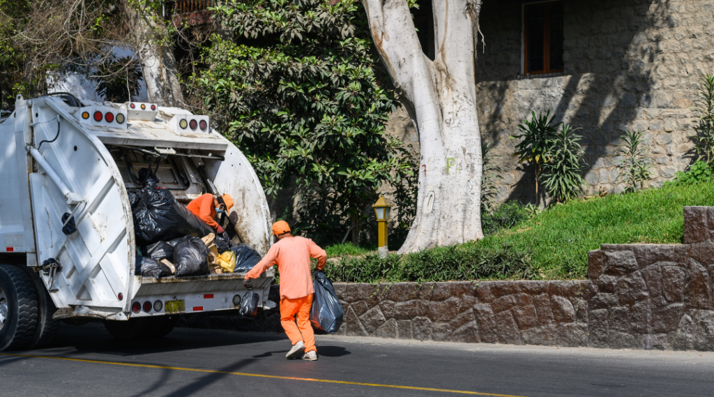 a garbage man picking the trash in Cockeysville