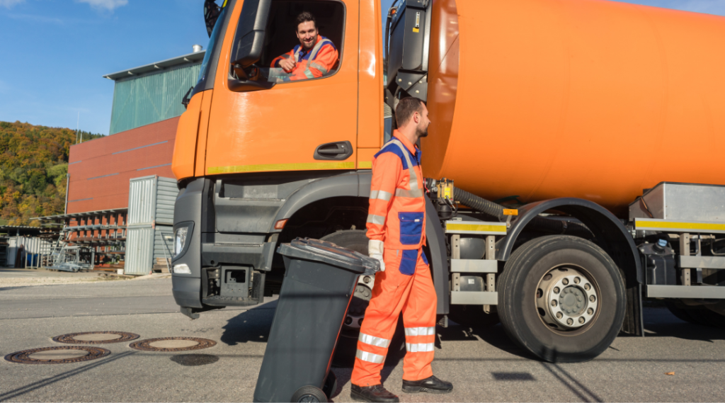 a huge dumpster rental truck with two worker