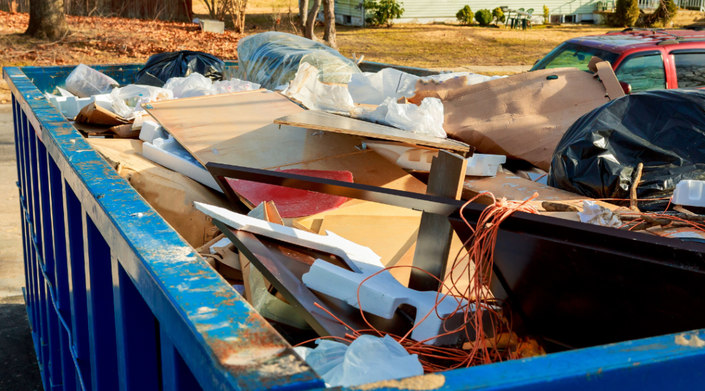 A blue dumpster container with a loaded garbage