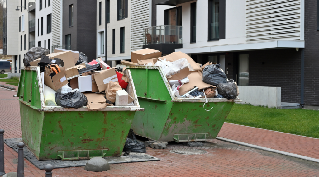 two green container with trash in it