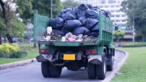 An overflowing dumpster with various types of waste