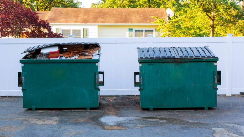 two green dumpster full of waste