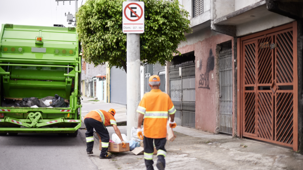 two garbage man collecting the trash