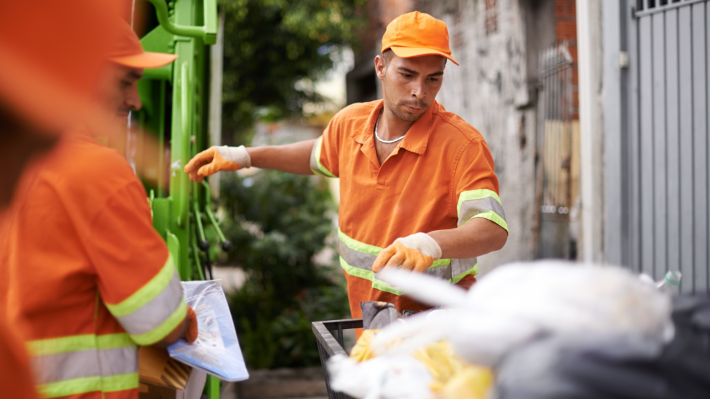 A sanitation worker removing trash