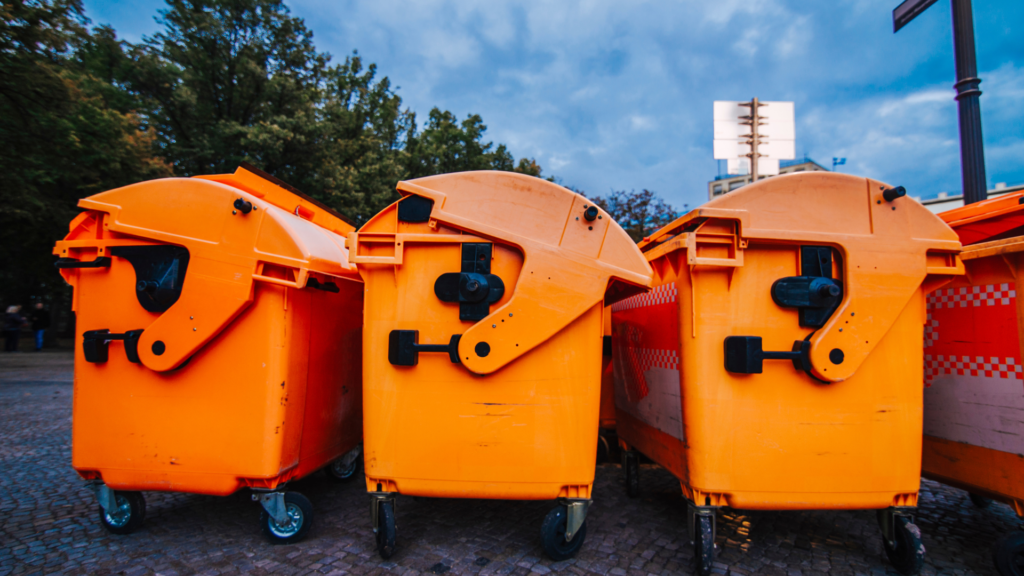 three yellow dumpster